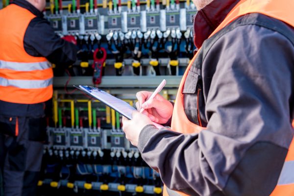 Checking the operating voltage levels of the solar panel switchgear compartment.