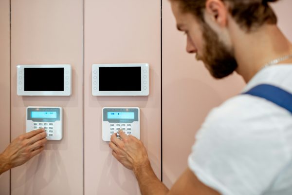 Man setting up the home alarm